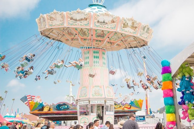 People enjoying ride on a day covered by rain insurance for state fairs