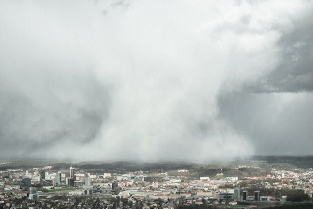 huge threatening storm clouds over a city showing why you need rain insurance during hurricane season